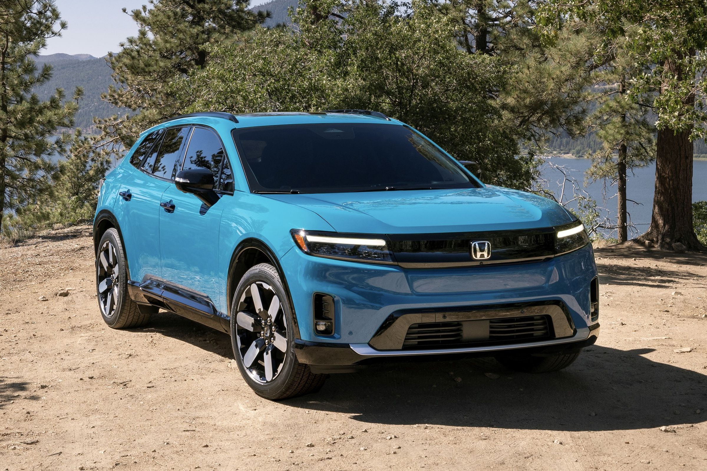 blue Honda SUV on a trail