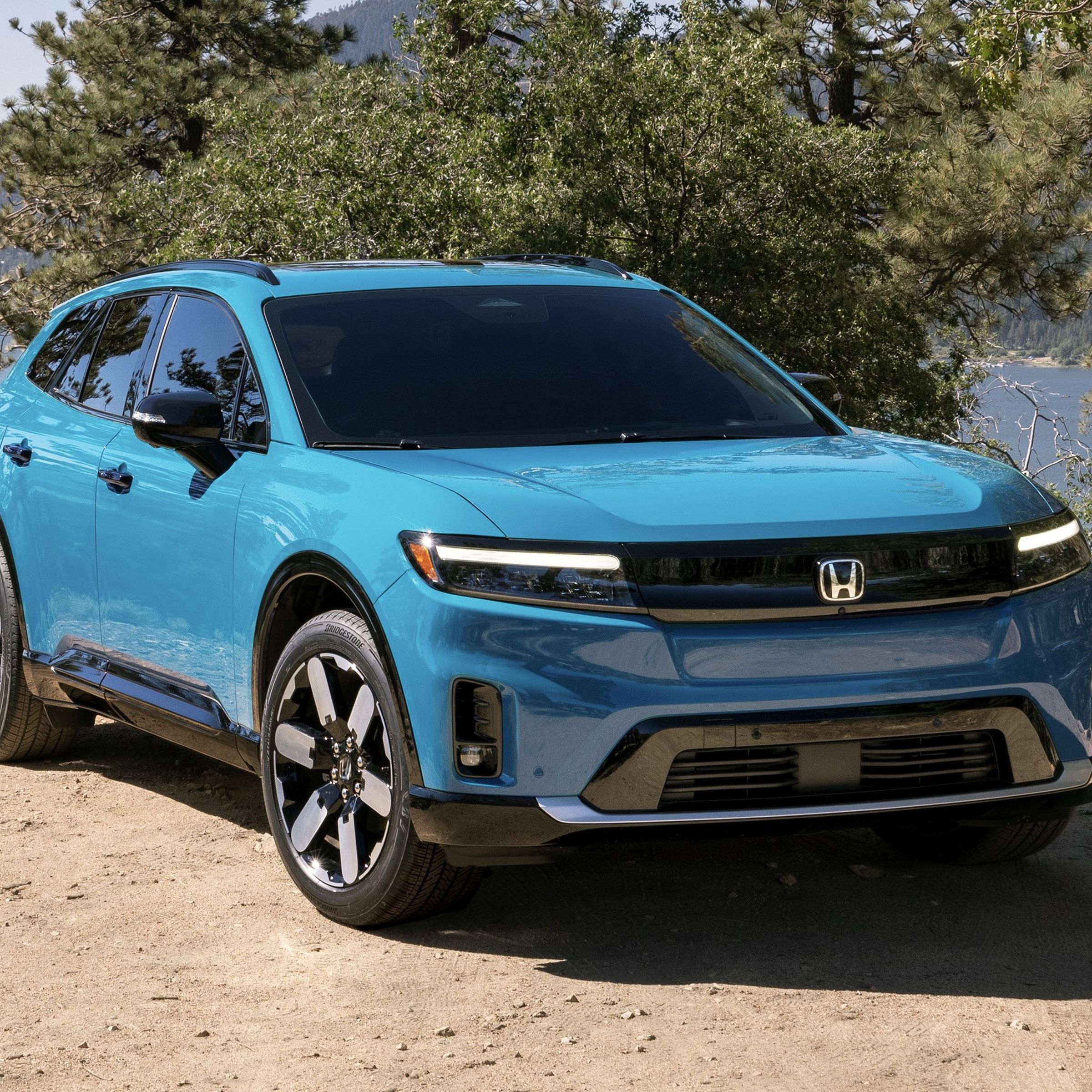 blue Honda SUV on a trail