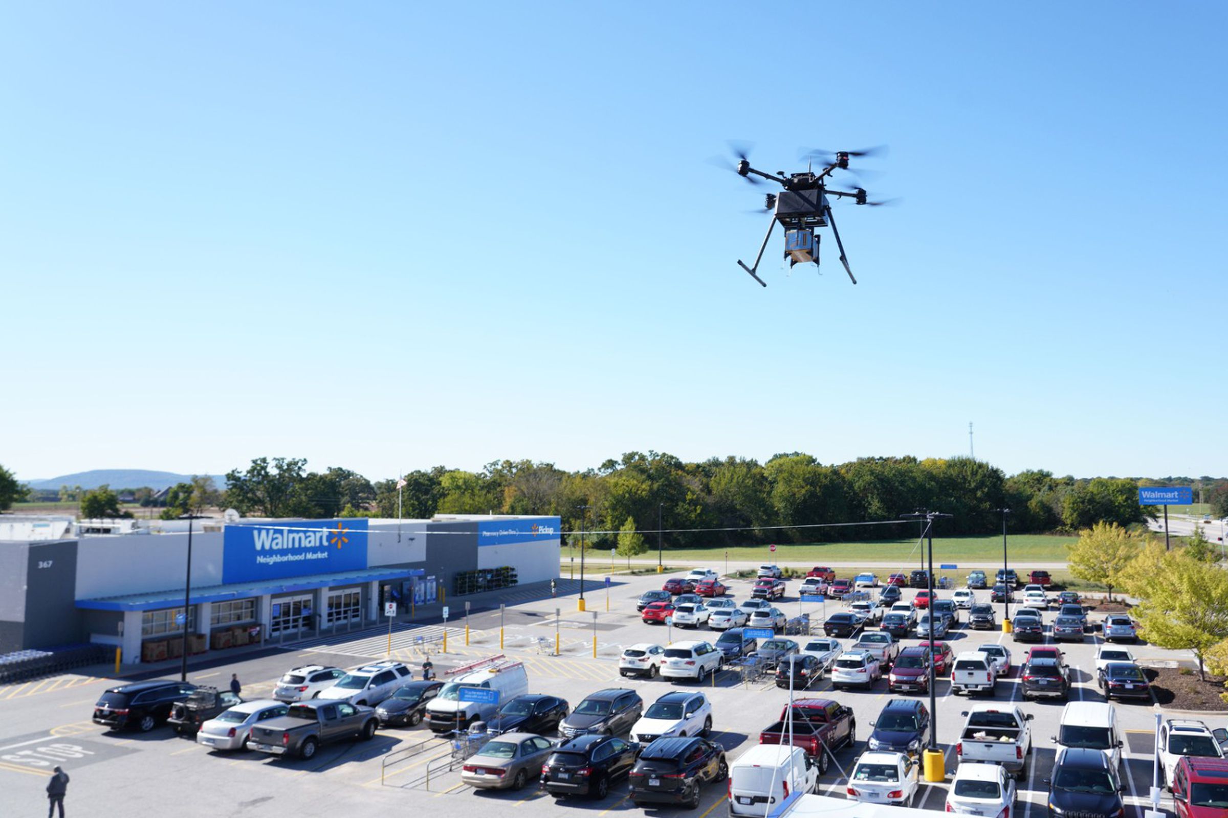 A DroneUp drone near a Walmart.