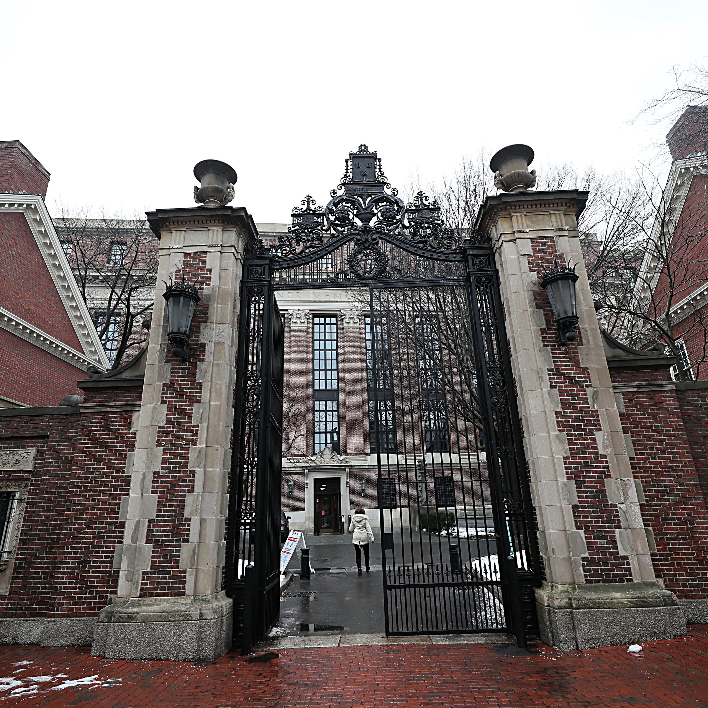 Large gates to the entrance of Harvard’s campus. The left side of the gate is open, and the other side is closed.