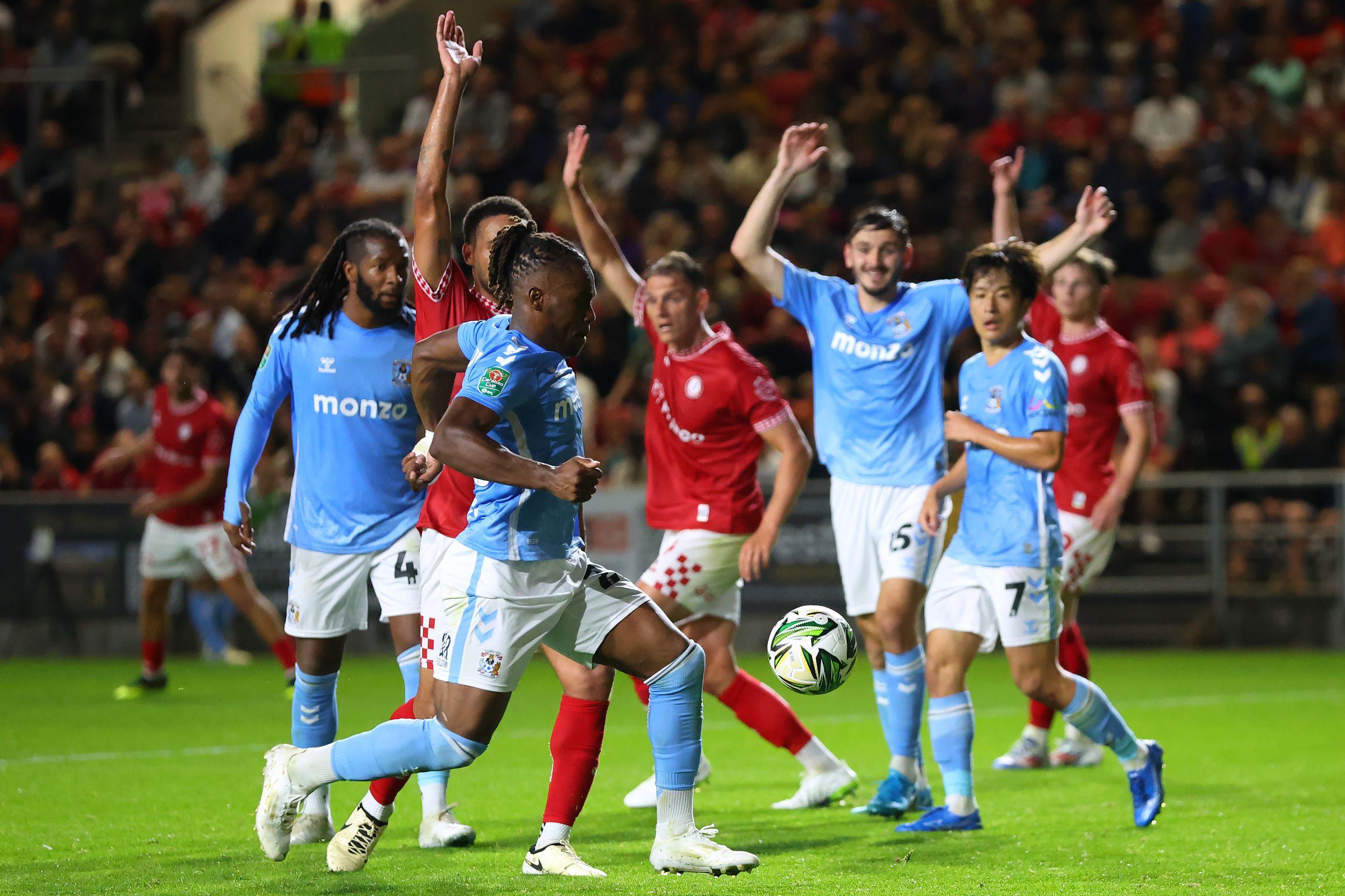 Players gathered together with their hands in the air.