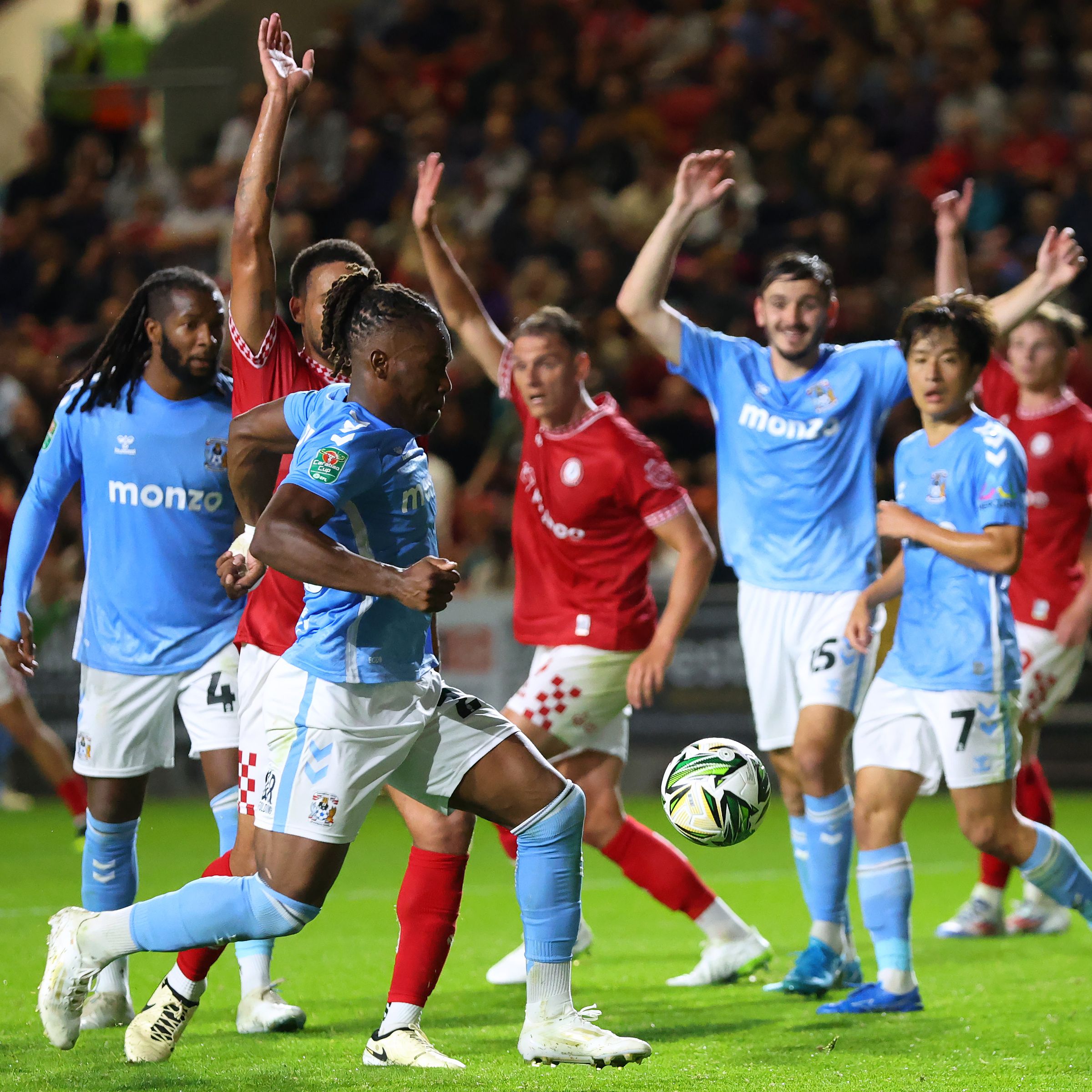 Players gathered together with their hands in the air.