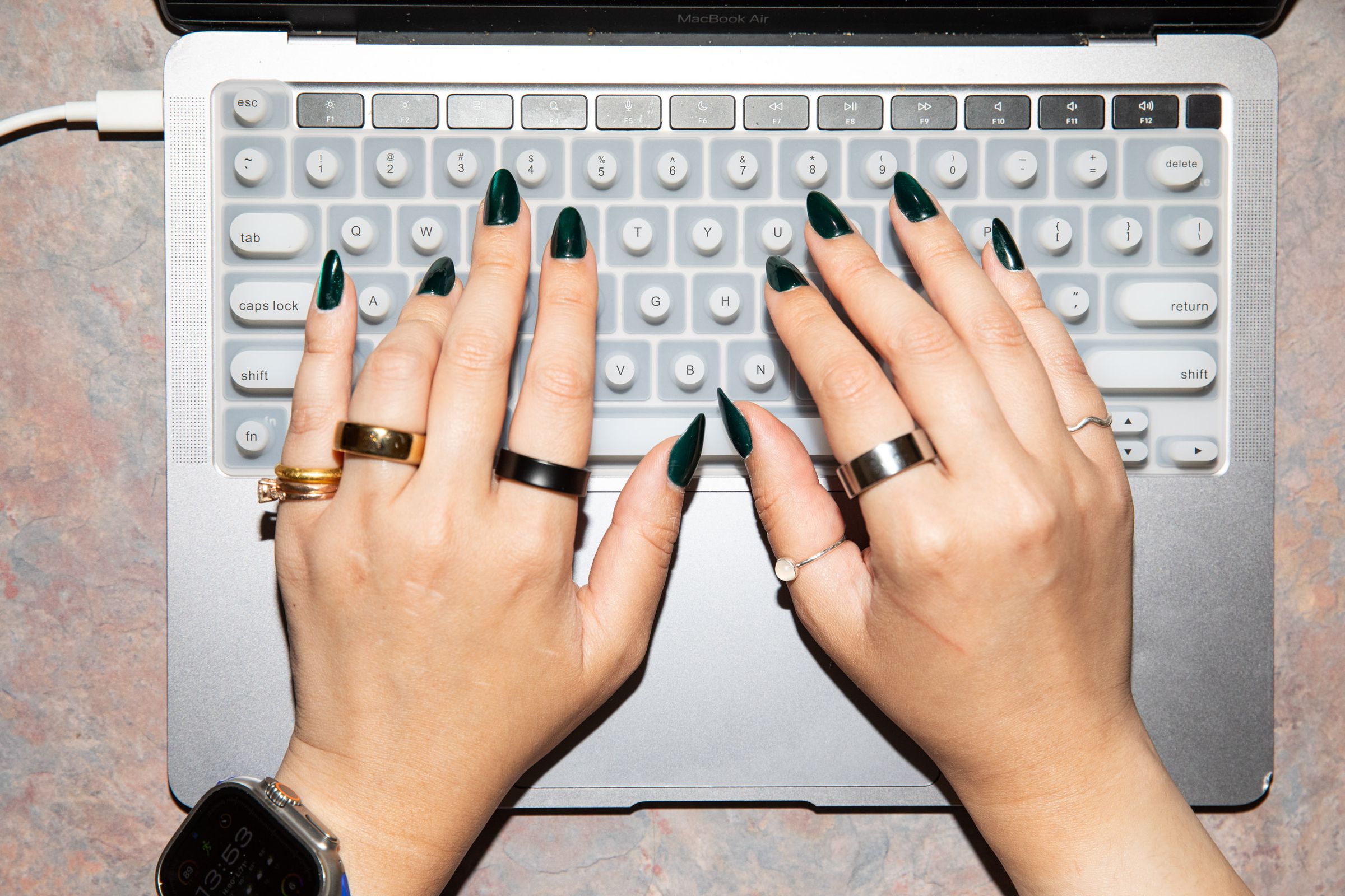 Person with long nails using the Tippy Type keyboard cover