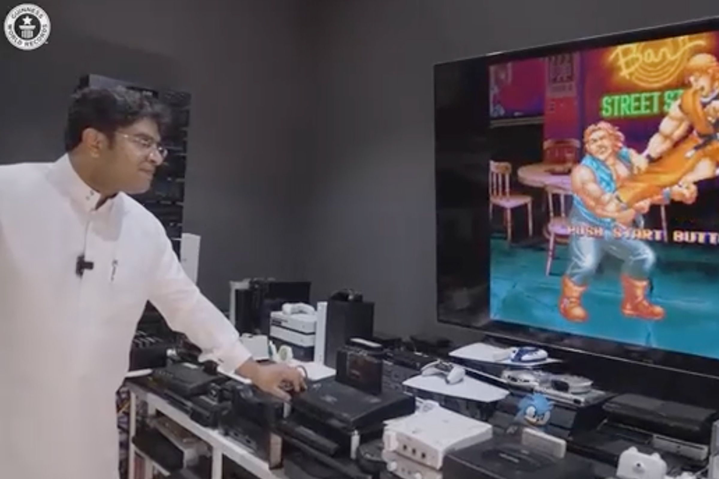 Ibrahim Al-Nasser demonstrating a Neo Geo console playing Street Fighter.