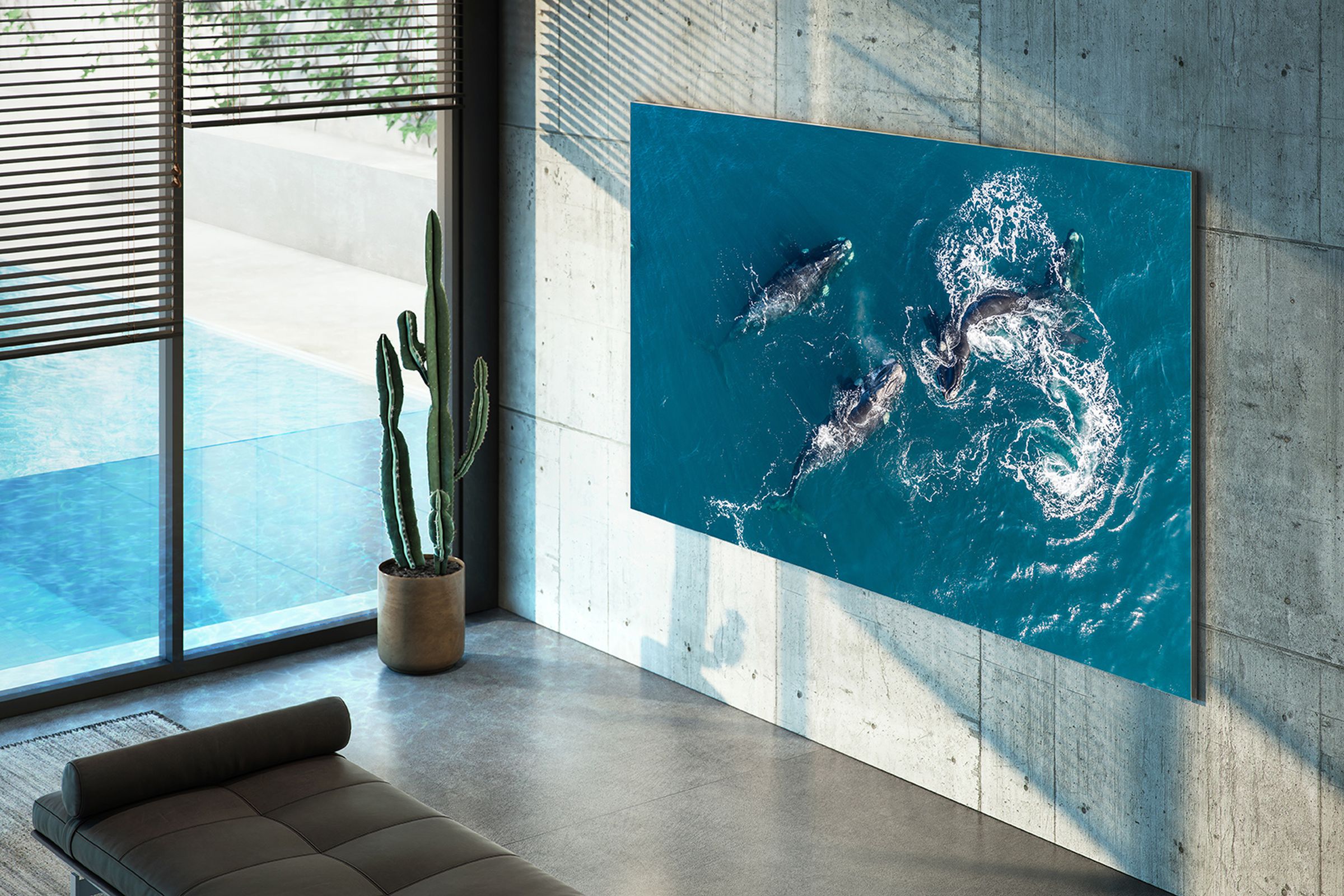 blue ocean wallpaper on a tv mounted on modern industrial tile home with ceiling to floor windows and lots of natural light.