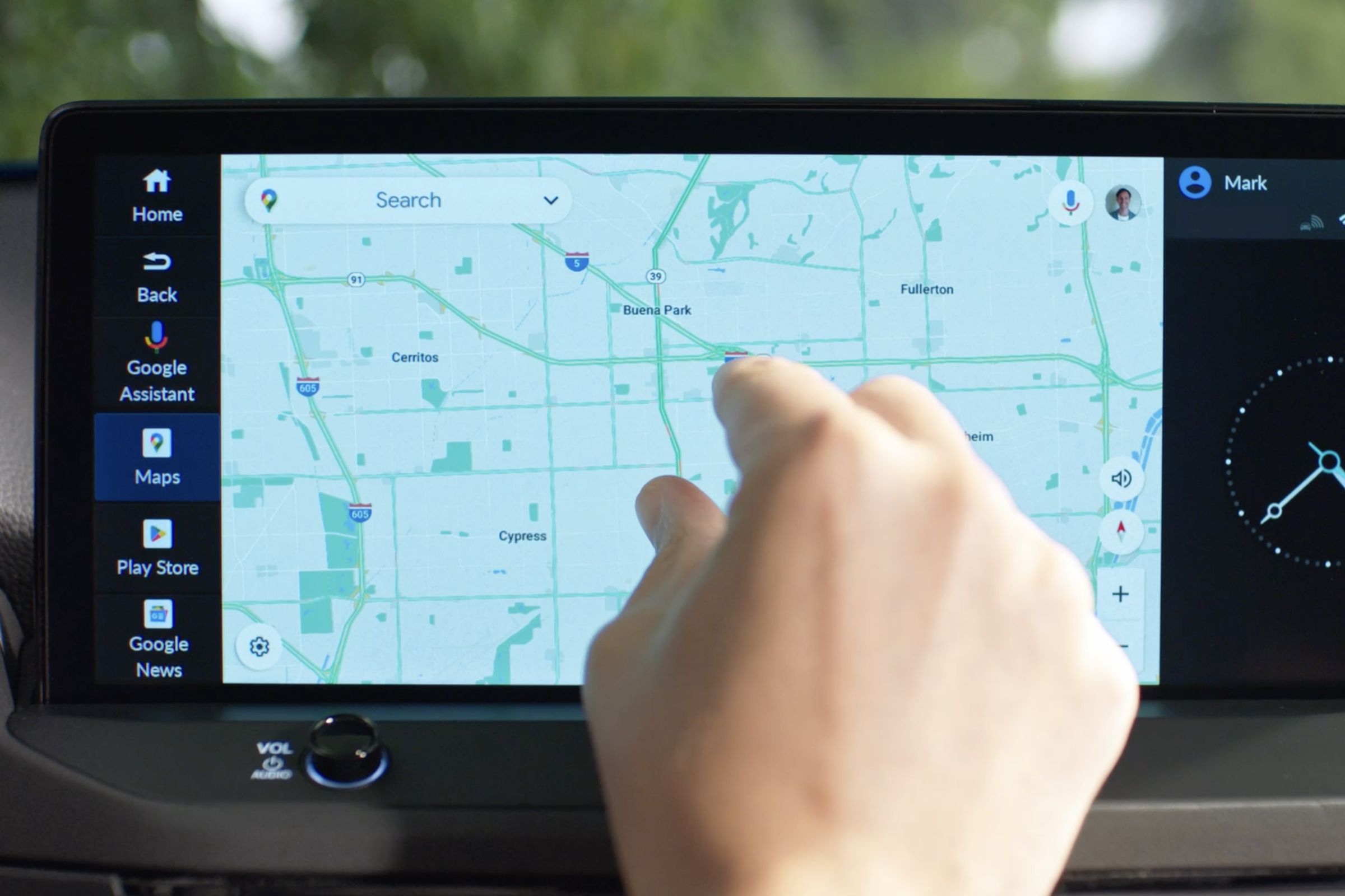 closeup of an infotainment screen in a Honda vehicle, with a hand pinching into the Google maps app.