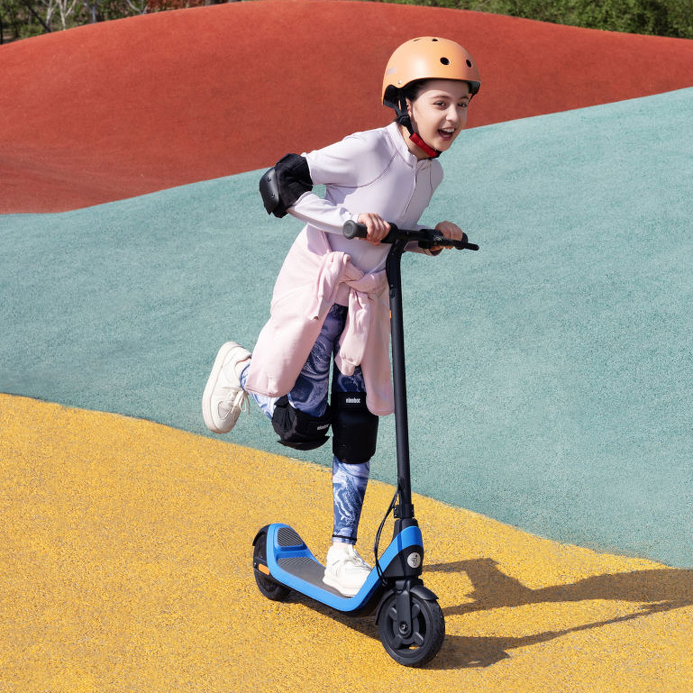 A child riding the Segway Ninebot eKickScooter C2 Lite using its power assist kick mode.